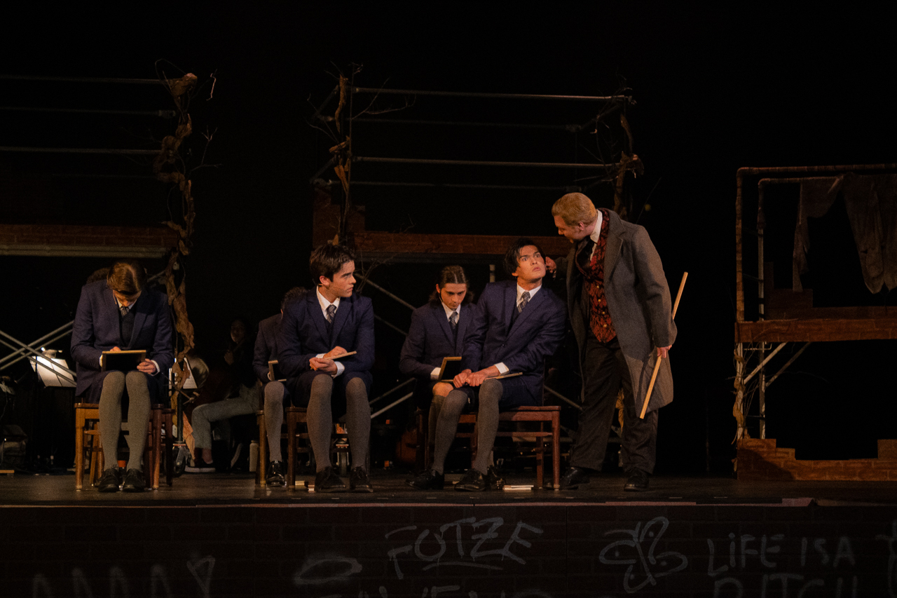 Spring Awakening ensemble crouched